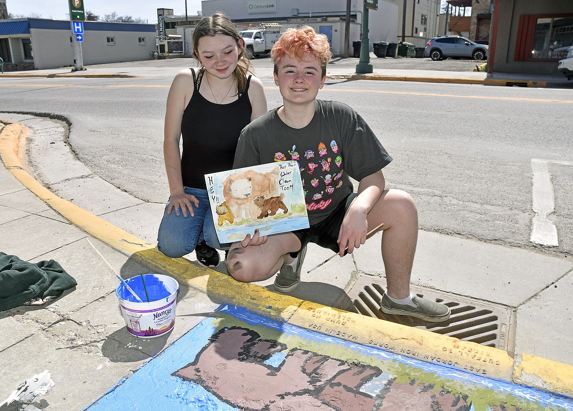 Kylie M. and Bugs S. show their plan for their mural on the first day of painting (Kelsey Evans/Whitefish Pilot).