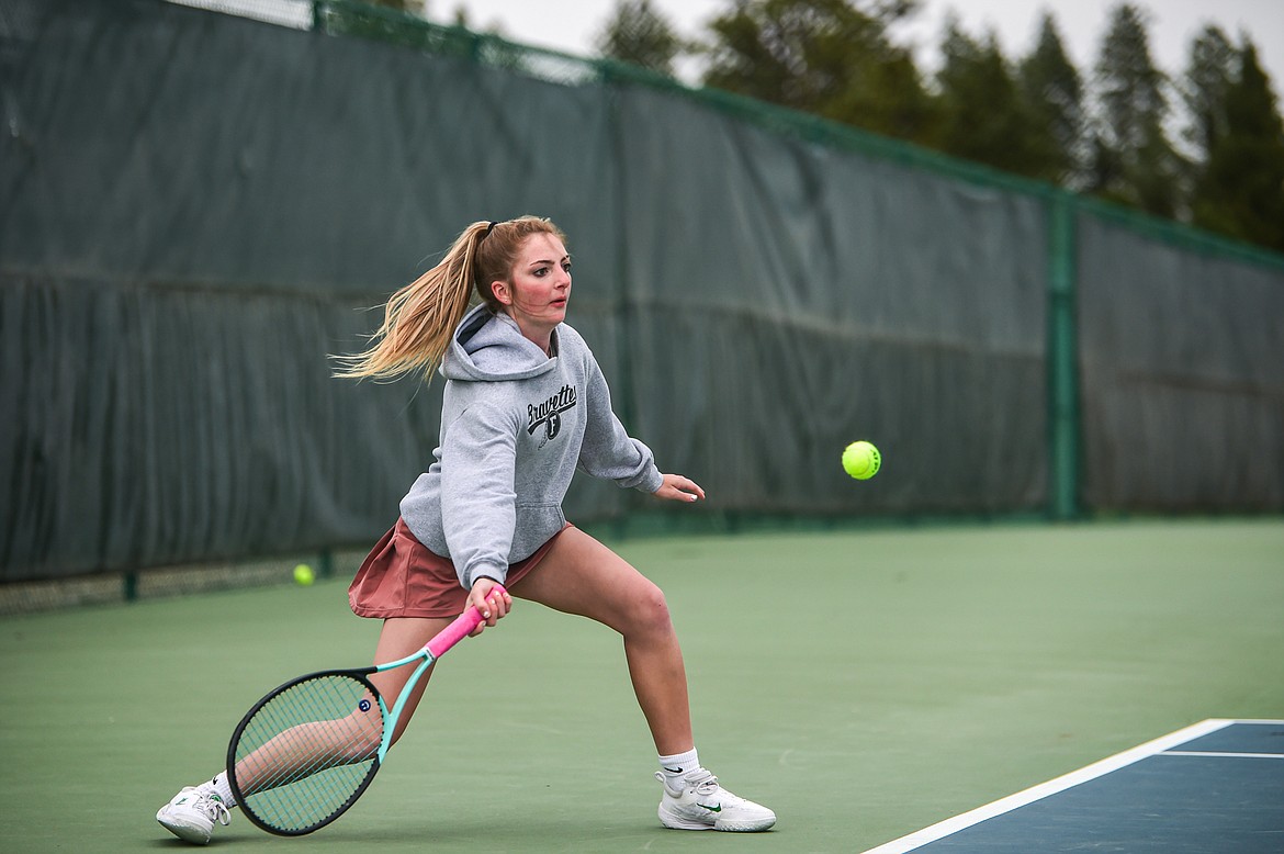 Flathead's Elle Westover hits a return in a girls singles match against Glacier's Leilani Lennarz at Flathead Valley Community College on Tuesday, May 7. (Casey Kreider/Daily Inter Lake)