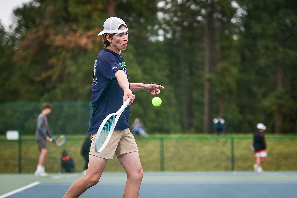 Glacier's Robbie Thornberg hits a return in a boys singles match against Flathead's Michael Palmer at Flathead Valley Community College on Tuesday, May 7. (Casey Kreider/Daily Inter Lake)