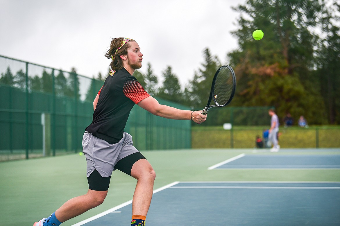 Flathead's Michael Palmer hits a return in a boys singles match against Glacier's Robbie Thornberg at Flathead Valley Community College on Tuesday, May 7. (Casey Kreider/Daily Inter Lake)