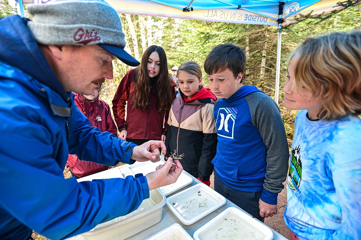 Dillon Tabish, Regional Communication and Education Program Manager with Montana Fish, Wildlife & Parks, shows a crayfish to students from Kirsten Pevey's fifth-grade class at Rankin Elementary School at the fisheries station of the Family Forestry Expo on Tuesday, May 7. (Casey Kreider/Daily Inter Lake)