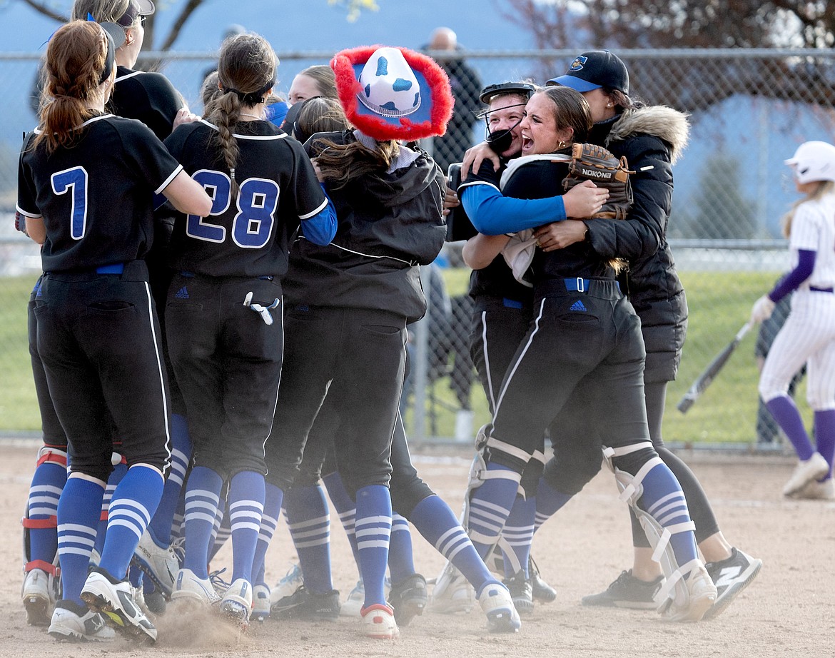 Courtesy photo
The Coeur d'Alene Vikings celebrate winning the 5A Region 1 softball championship by beating the Lewiston Bengals on Tuesday at Larry Schwenke Field. At right, pitcher Jenna Davenport, catcher Kyndal Bridge and head coach Bobbi Daretta embrace the win.