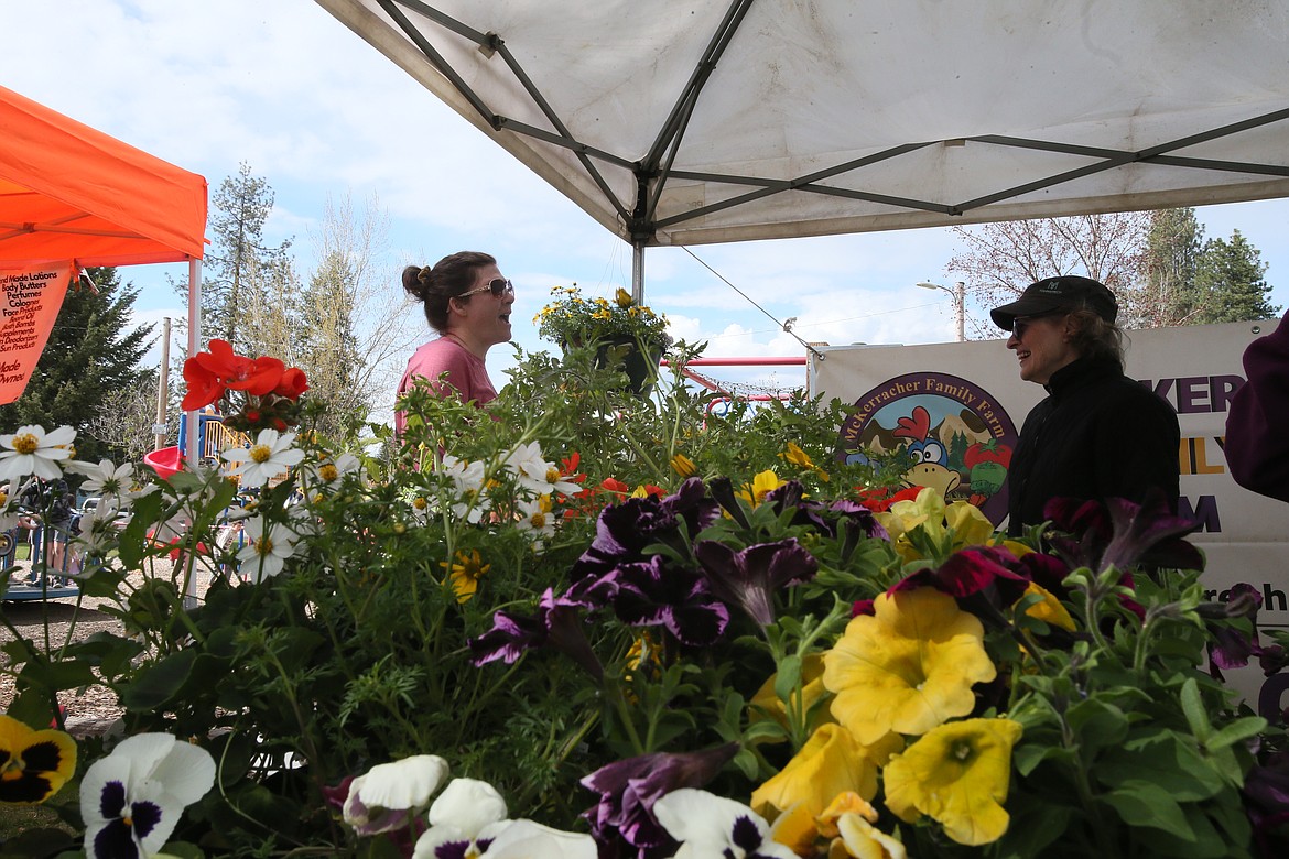 Barbara Grinstead of Garwood, left, chats with Kathy Martz at the McKerracher Family Farm stand Friday at the Athol Farmers Market. This year's market features 22 full-season vendors as well as several rotating pop-in vendors.