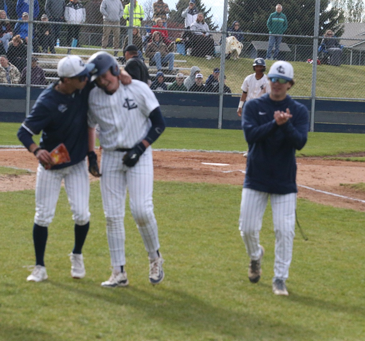 JASON ELLIOTT/Press
Lake City junior outfielder Jack Pierce hugs senior Charlie Dixon after Dixon's solo home run to give the Timberwolves a 1-0 lead in the third inning the 5A Region 1 baseball championship game at Lake City High on Tuesday. Also pictured is AJ Currie.