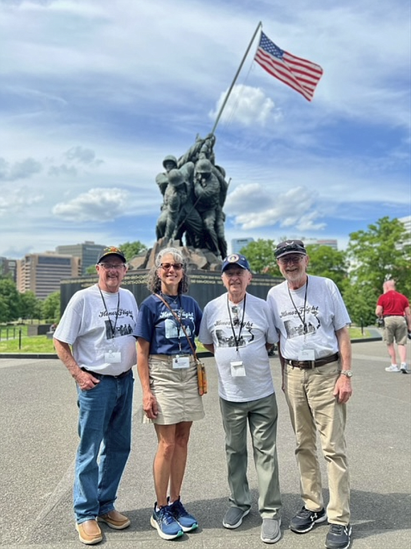 Joe Deacon and his brothers, Tom and Bill Deacon, and their Honor Flight guardian, Gina Cadagan, stand in front of a memorial statue in Washington D.C. The brothers were able to attend the event together although they live in different states. From left: Tom Deacon, Gina Cadagan, Bill Deacon and Joe Deacon.