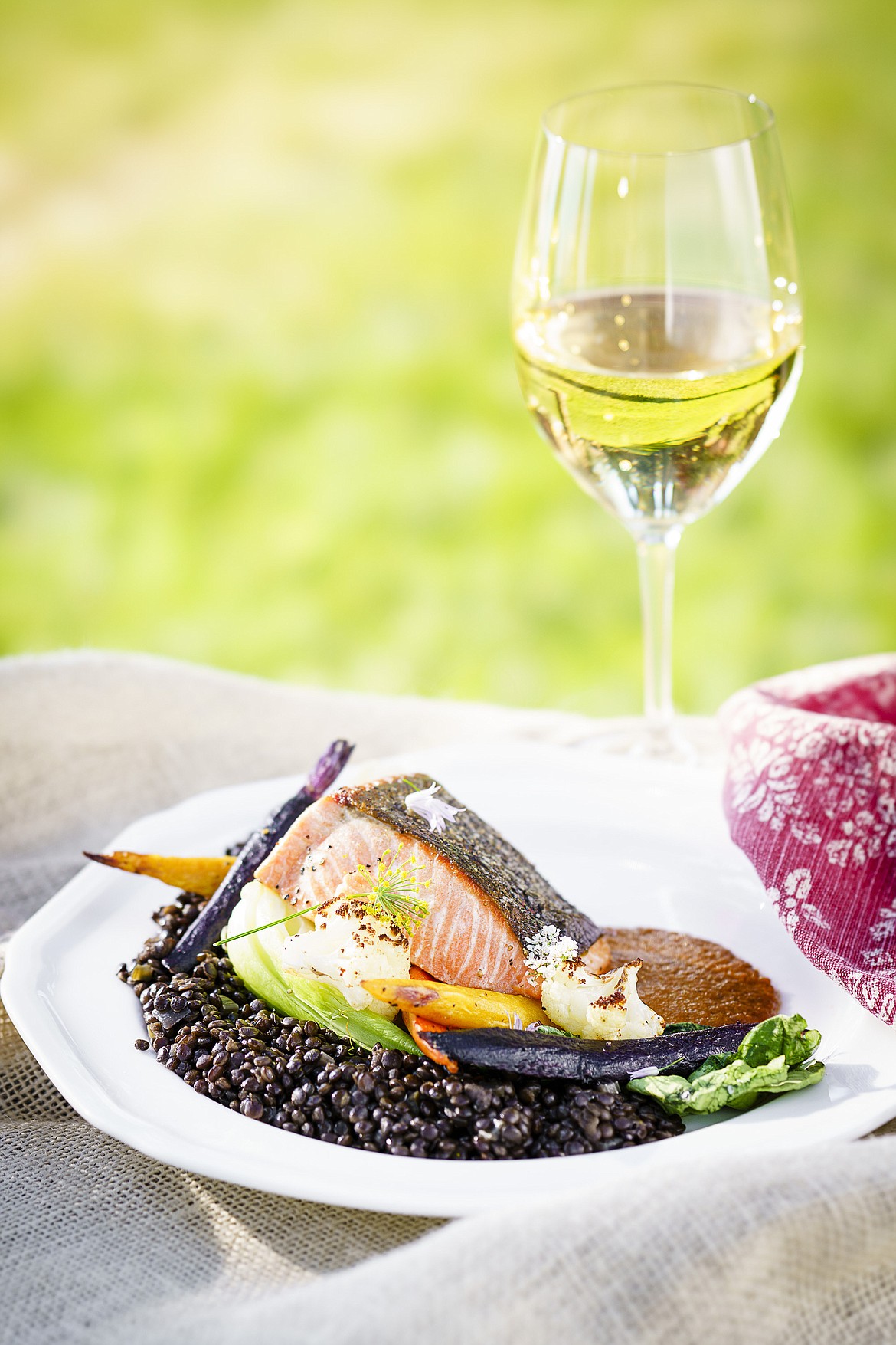 Salmon with beluga lentils, carrots, cauliflower, Swiss chard, and a red pepper coulis is served at Flathead Lake Lodge. (Courtesy photo)