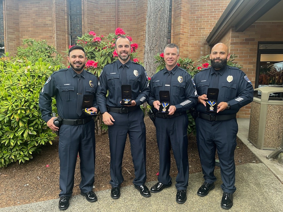 From left to right, Corp. Omar Ramirez, Officer Curt Ledeboer, Det. Sgt. Kyle McCain and Det. Edgar Salazar of the Moses Lake Police Department pose with their Washington State Medal of Honor after receiving the awards Friday.