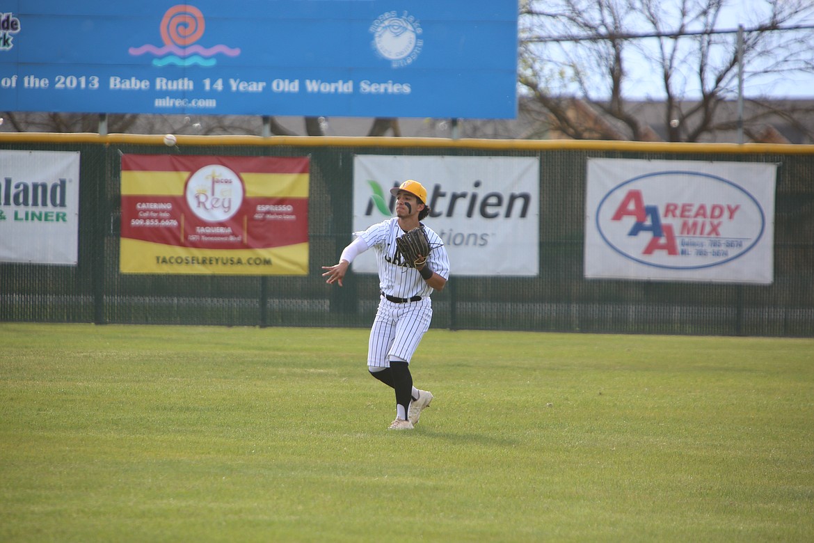 Moses Lake junior Jackson Carlos tosses the ball back toward the infield during the 4-1 win over West Valley (Yakima) on April 30. The Mavericks swept the Rams on Friday to earn a share of the Columbia Basin Big 9 league title.