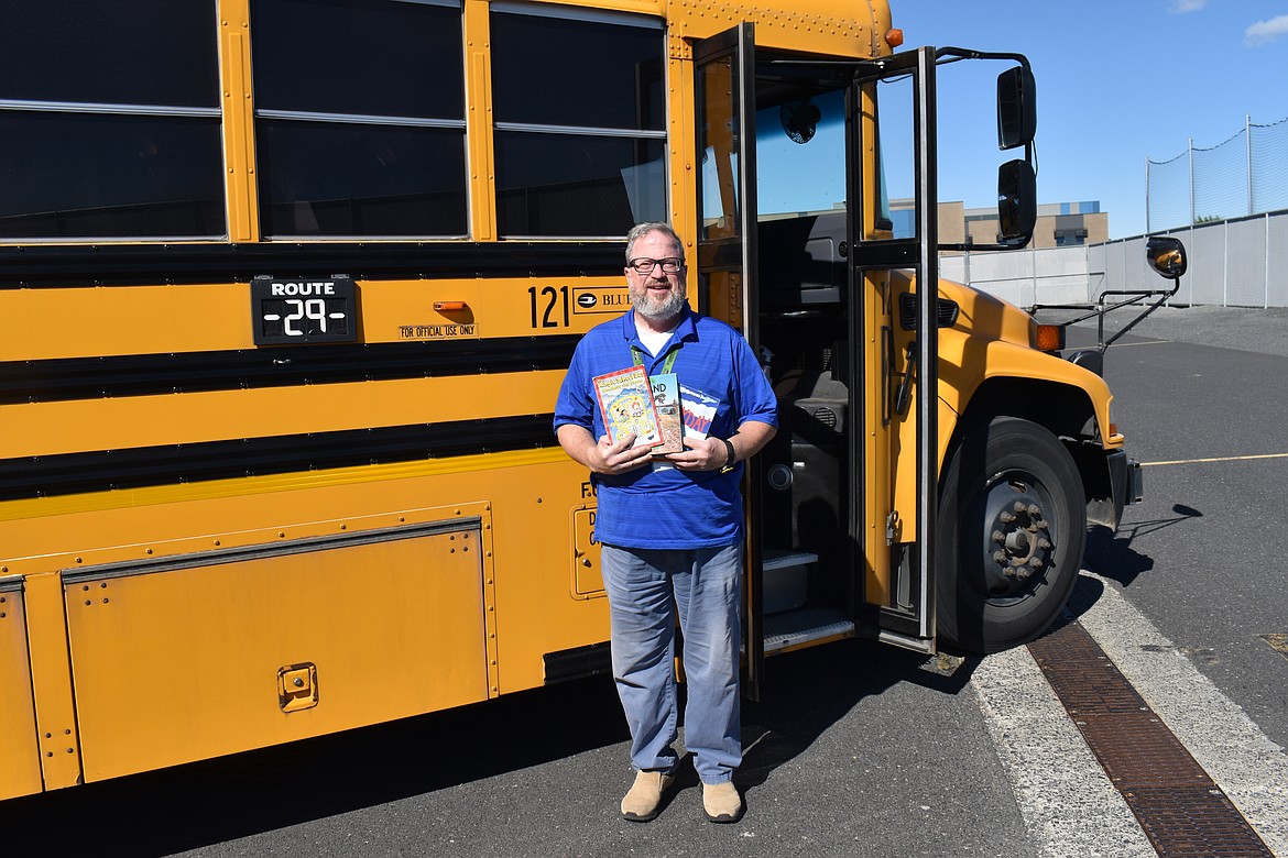 Moses Lake school bus driver Tony Lavelle, known to his students as Mr. Tony, shows some of the books he’s collected for his students to read on the bus or take home at the end of the year.