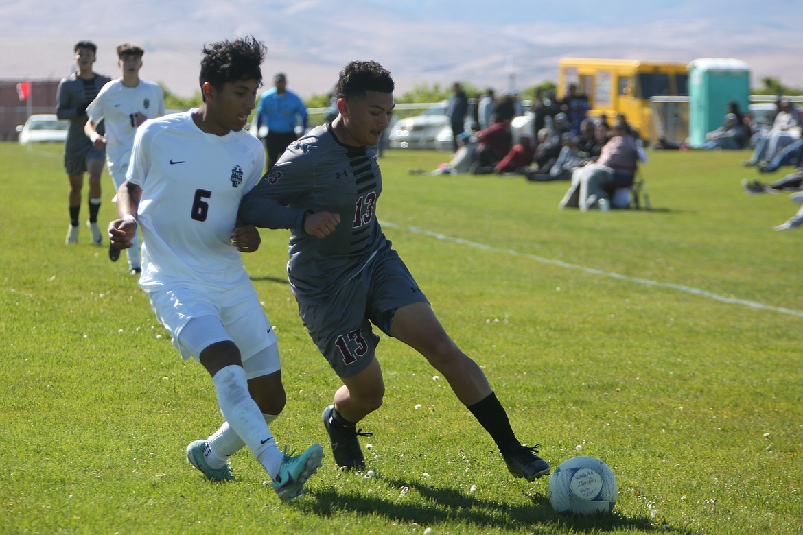 Wahluke junior Luis Corona (13) rushes past a Toppenish defender in the first half of Tuesday’s 3-2 shootout win over the Wildcats.