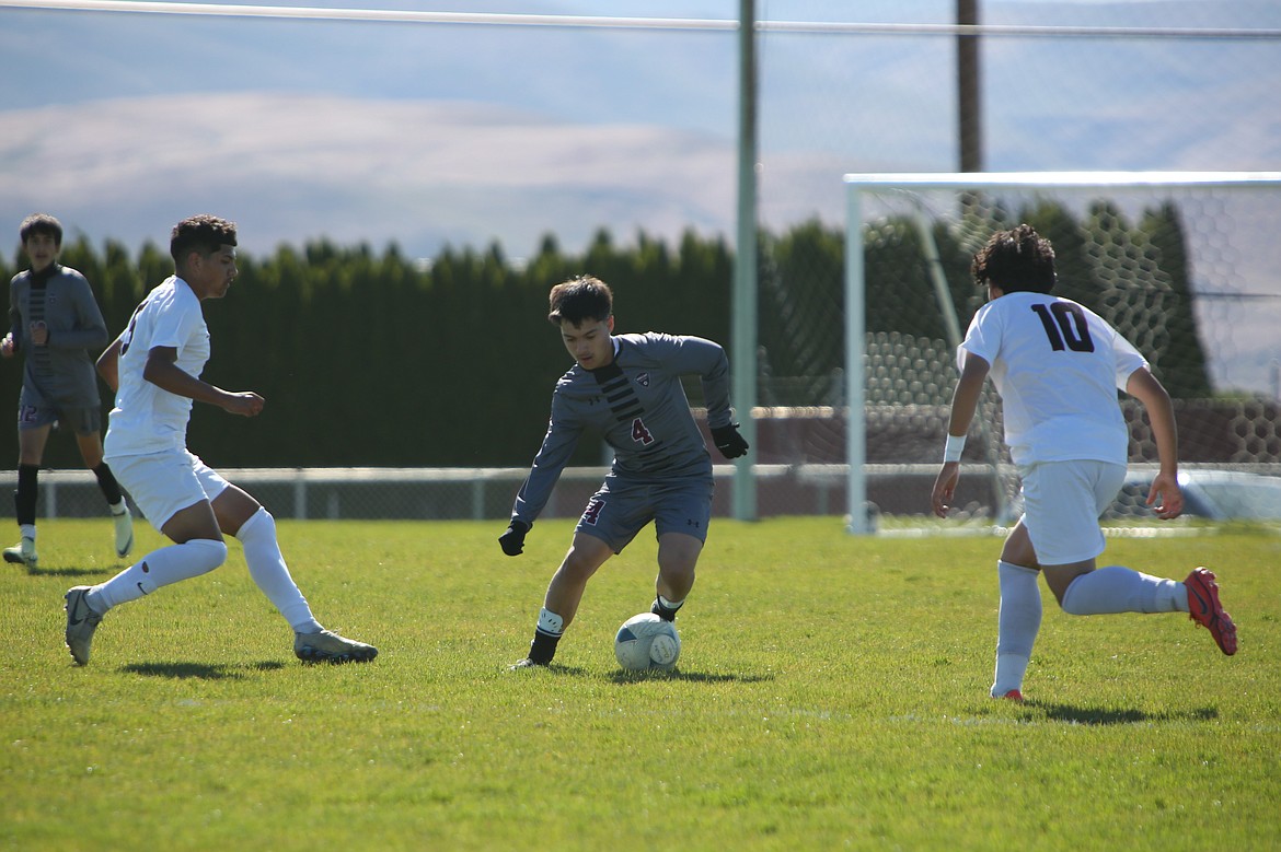 Wahluke junior Alvaro Rodriguez (4) looks to weave his way through two Toppenish defenders in Tuesday’s match against the Wildcats.