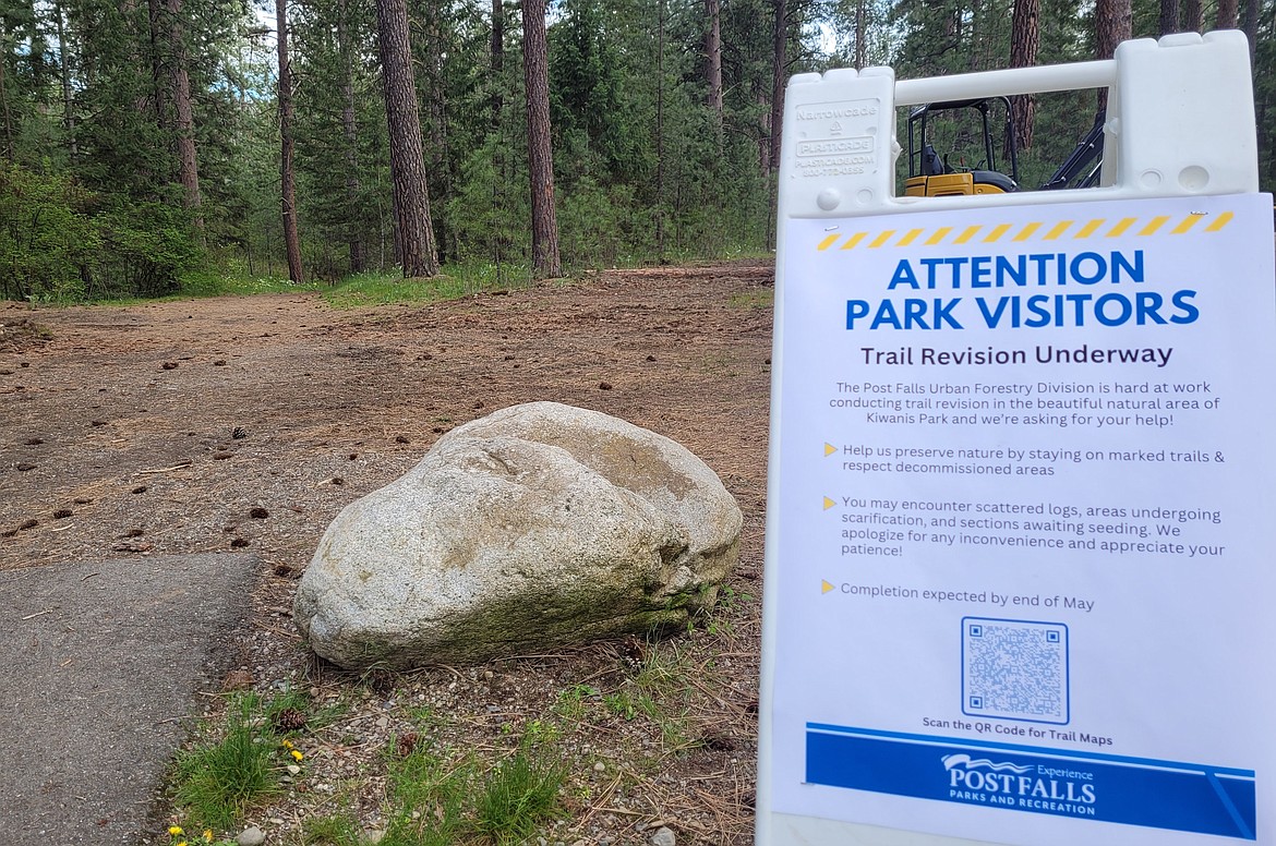 A signboard is posted to let people know Trail revision is underway at Kiwanis Park.