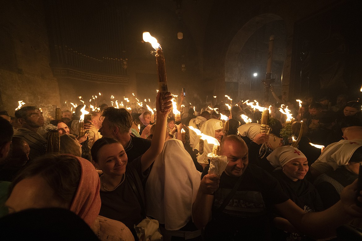 A Christian Orthodox pilgrim holds up a candle Saturday, May 4, in the Old City of Jerusalem, during the Holy Fire ceremony at the Church of the Holy Sepulchre, where many Christians believe Jesus was crucified, buried and rose from the dead. In the annual ceremony, held that has been observed for over a millennium, a flame taken from Jesus' tomb is used to light the candles of fervent believers of Christian Orthodox communities near and far. The devout believe the origin of the flame is a miracle and is shrouded in mystery.