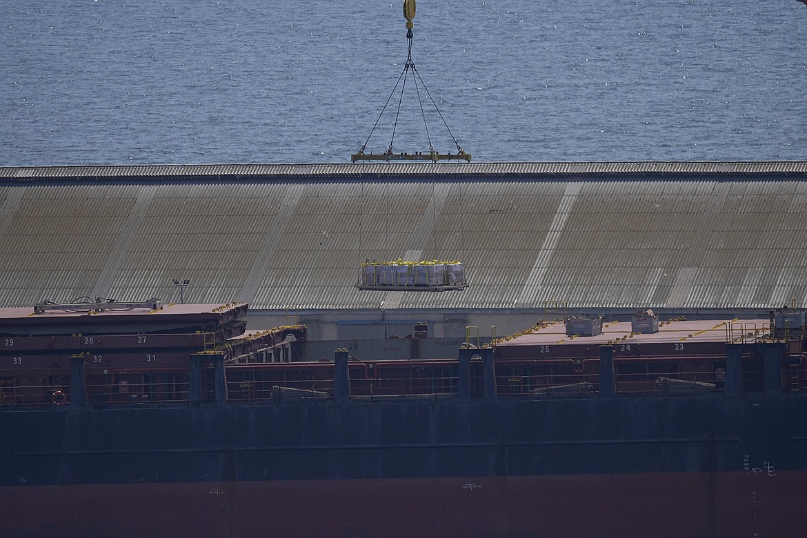 A crane loads food aid for Gaza onto the container ship Sagamore docked at Larnaca port, Cyprus, Wednesday, May 8, 2024. (AP Photo/Petros Karadjias)