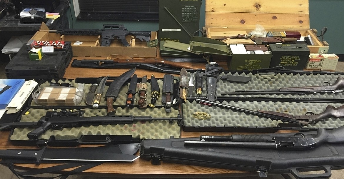 This undated photo provided by the Van Buren County Sheriff's Office in Paw Paw, Mich., shows stolen guns, ammunition and knives that were recovered Sept. 12, 2015, in Antwerp Township, Mich. The rate of guns stolen from cars in the U.S. has tripled over the last decade, making them the largest source of stolen guns in the country, a new analysis of FBI data by the gun-safety group Everytown found. (Van Buren County Sheriff's Office via AP)