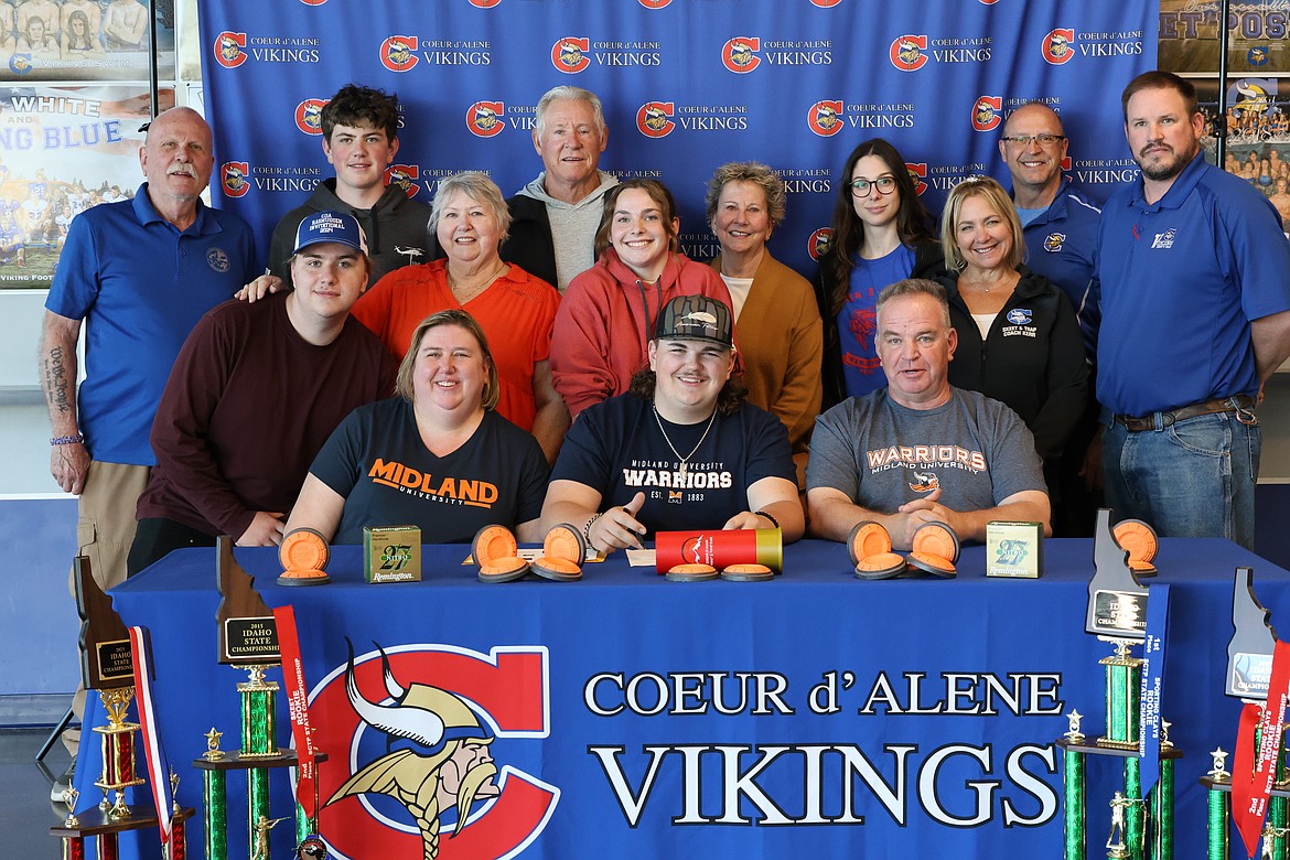 Courtesy photo
Coeur d'Alene High senior Hunter Martin recently signed a letter of intent with Midland University in Fremont, Neb., for a full scholarship in competitive shooting. Seated from left are Courtney Martin, Hunter Martin and Brian Martin; second row from left, Spencer Martin, Nancy Miller, Chiara Lehman, coach Kirsten Kerr and coach Matt Brown; and back row from left, coach Bob Thornton, Parker Martin, Larry Bell, Patricia Bell, Coeur d'Alene High athletic director Victoria Beecher and coach Chuck Keisel.