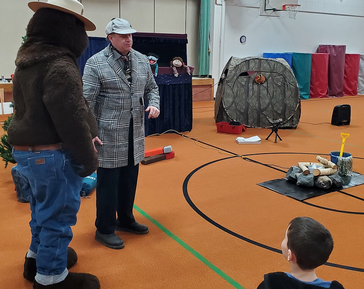 Smoky Bear and a friend perform a fire prevention safety skit for first graders.