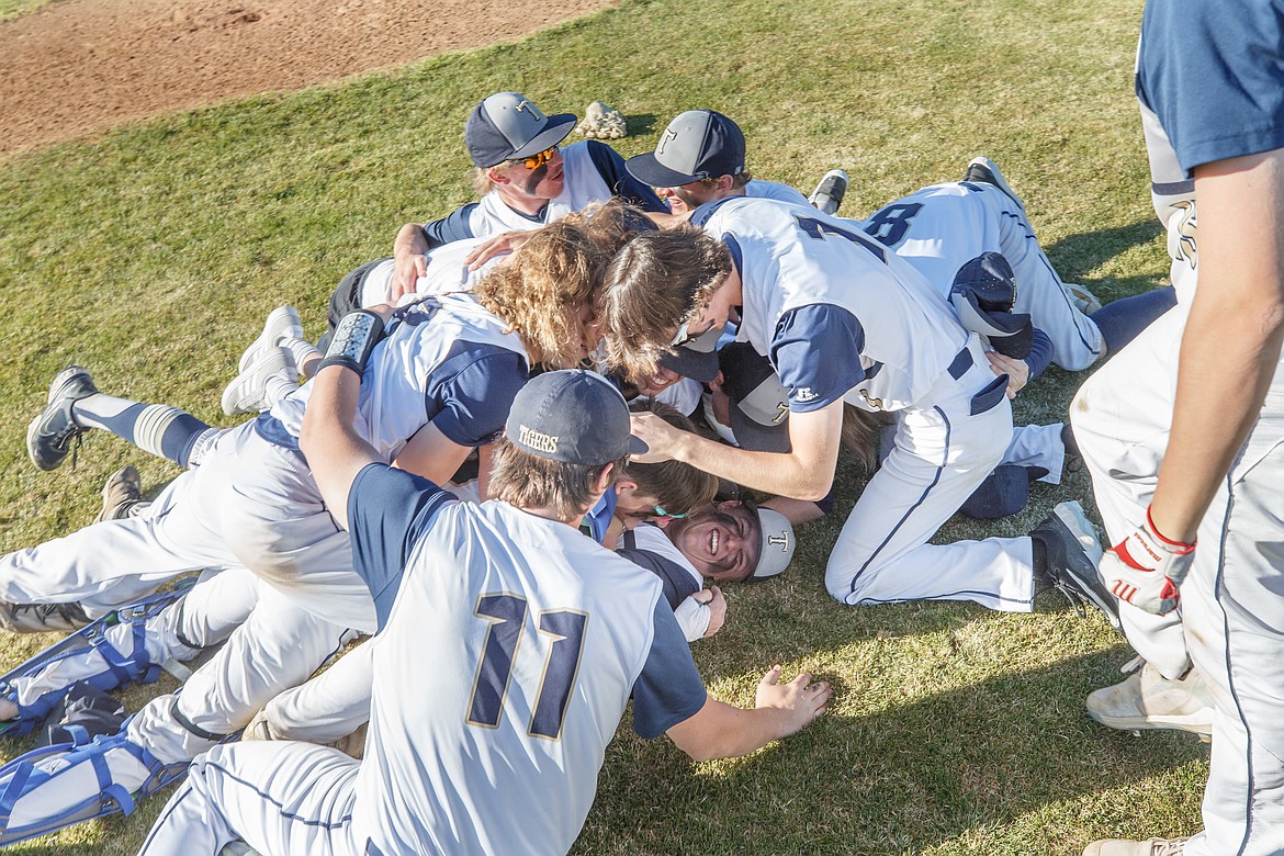 JASON DUCHOW PHOTOGRAPHY
Timberlake players dogpile on starting pitcher Grant Allaway after the Tigers beat the Bonners Ferry Badgers on Thursday in Spirit Lake to sweep their best-of-3 series for the 3A District 1 baseball title.