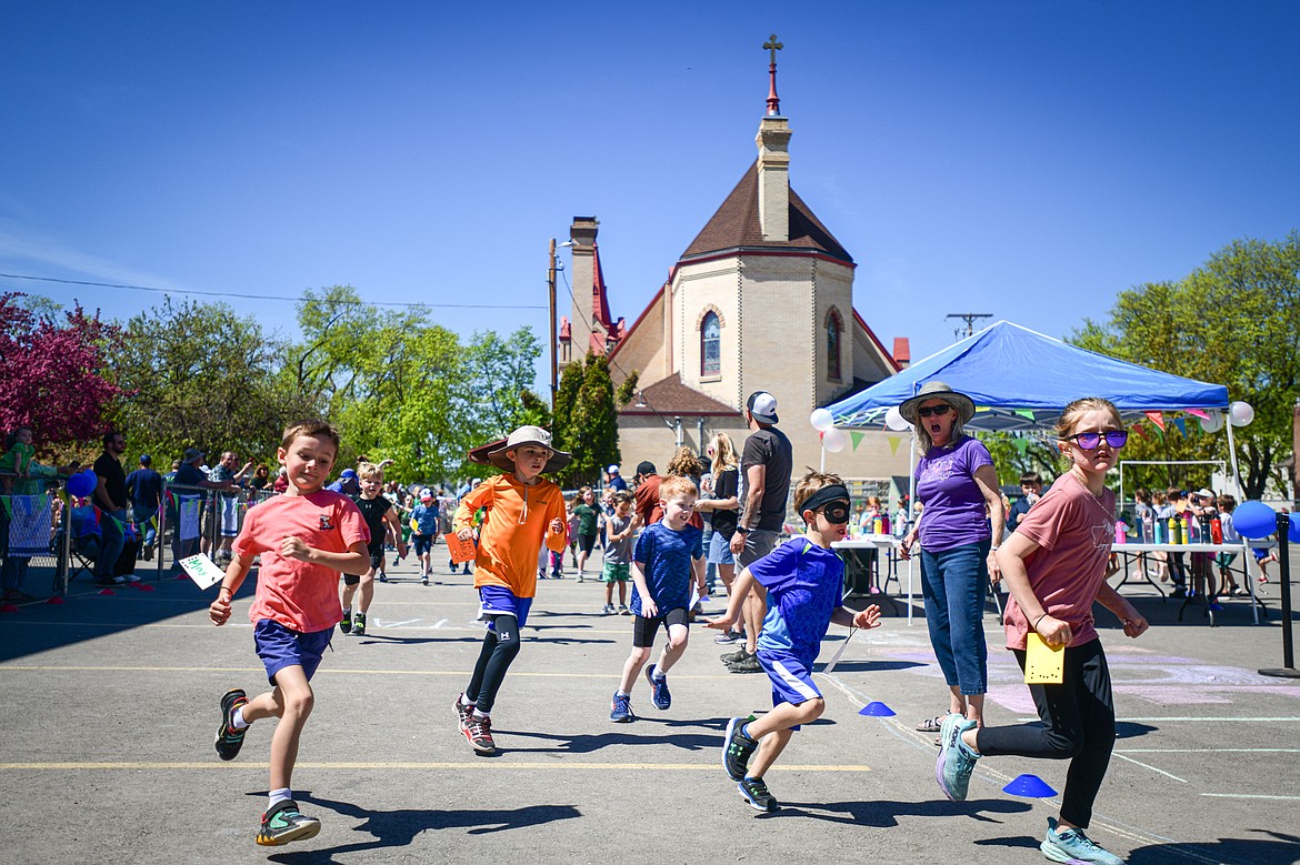 St. Matthew's School students in grades kindergarten through second grade participate in an all-school fundraising fun run with the goal of raising $20,000 for teacher continuing education and training on Friday, May 10. (Casey Kreider/Daily Inter Lake)