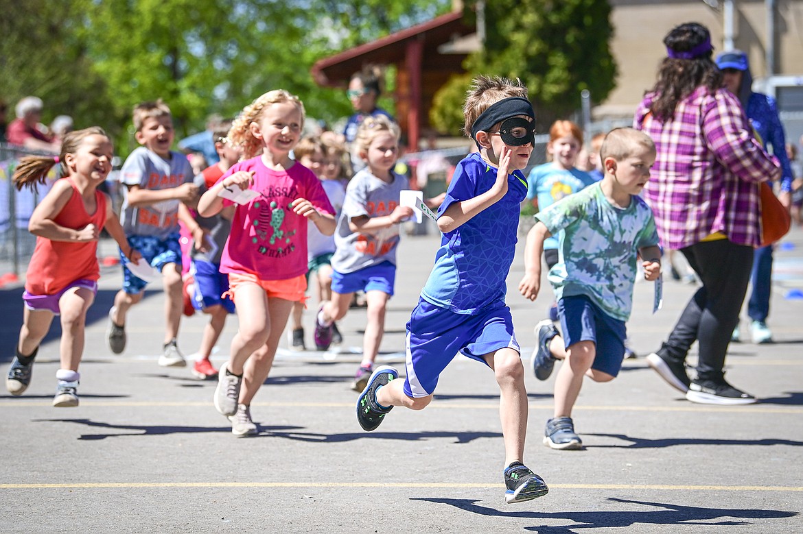 St. Matthew's School students in grades kindergarten through second grade participate in an all-school fundraising fun run with the goal of raising $20,000 for teacher continuing education and training on Friday, May 10. (Casey Kreider/Daily Inter Lake)