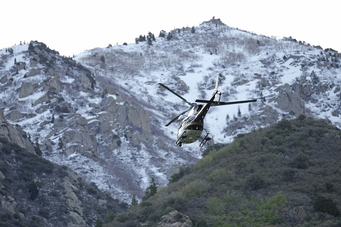 A Utah Department of Public Safety helicopter carries recovery crews from a staging area Friday, May 10, 2024, in Sandy, Utah. Two backcountry skiers were killed and one was rescued after an avalanche Thursday, in the mountains outside of Salt Lake City. (AP Photo/Rick Bowmer)