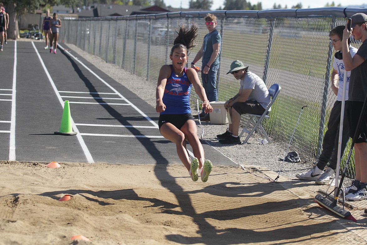 JASON ELLIOTT/Press
Coeur d'Alene High senior Maddie Mitchell attempts to stick the landing during an attempt in the girls long jump at the 5A Region 1 track and field meet at Coeur d'Alene High on Thursday. Mitchell finished third in the event to qualify for state next Friday and Saturday at Mountain View High in Meridian.