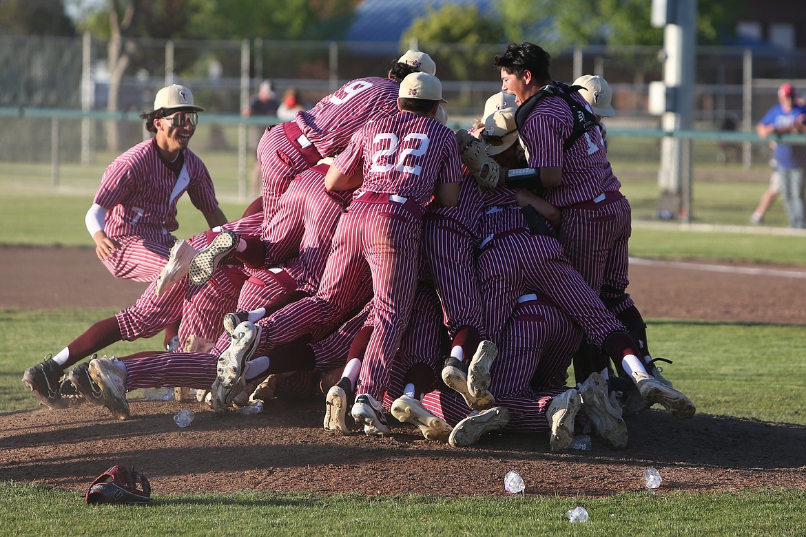 Moses Lake baseball players dogpile on the pitching mound after defeating Eastmont 8-2 in Friday’s Columbia Basin Big 9 district championship game in Moses Lake.