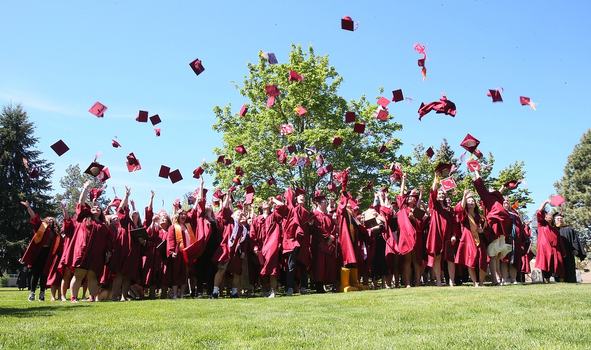 North Idaho College 2024 graduates enthusiastically toss mortarboards and at least one gown into the sky Friday morning at the conclusion of their commencement ceremony.