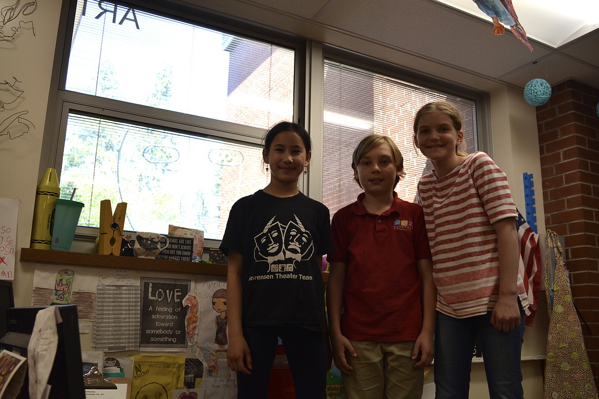 Fourth graders Eleanor Casile, Noah D’Alessandro and Birdie Bailey pose by the window in the art room at Sorensen Magnet School, where Buddy Paul's sculpture, "A Very Large Cat" is now visible.