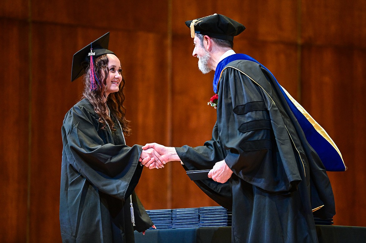 A graduate smiles as she receives her degree from Bryan Brophy-Baermann, vice president of Academic and Student Affairs, at Flathead Valley Community College's Class of 2024 commencement ceremony inside McClaren Hall at the Wachholz College Center on Friday, May 10. A total of 271 students were honored earning 292 degrees and certificates. (Casey Kreider/Daily Inter Lake)