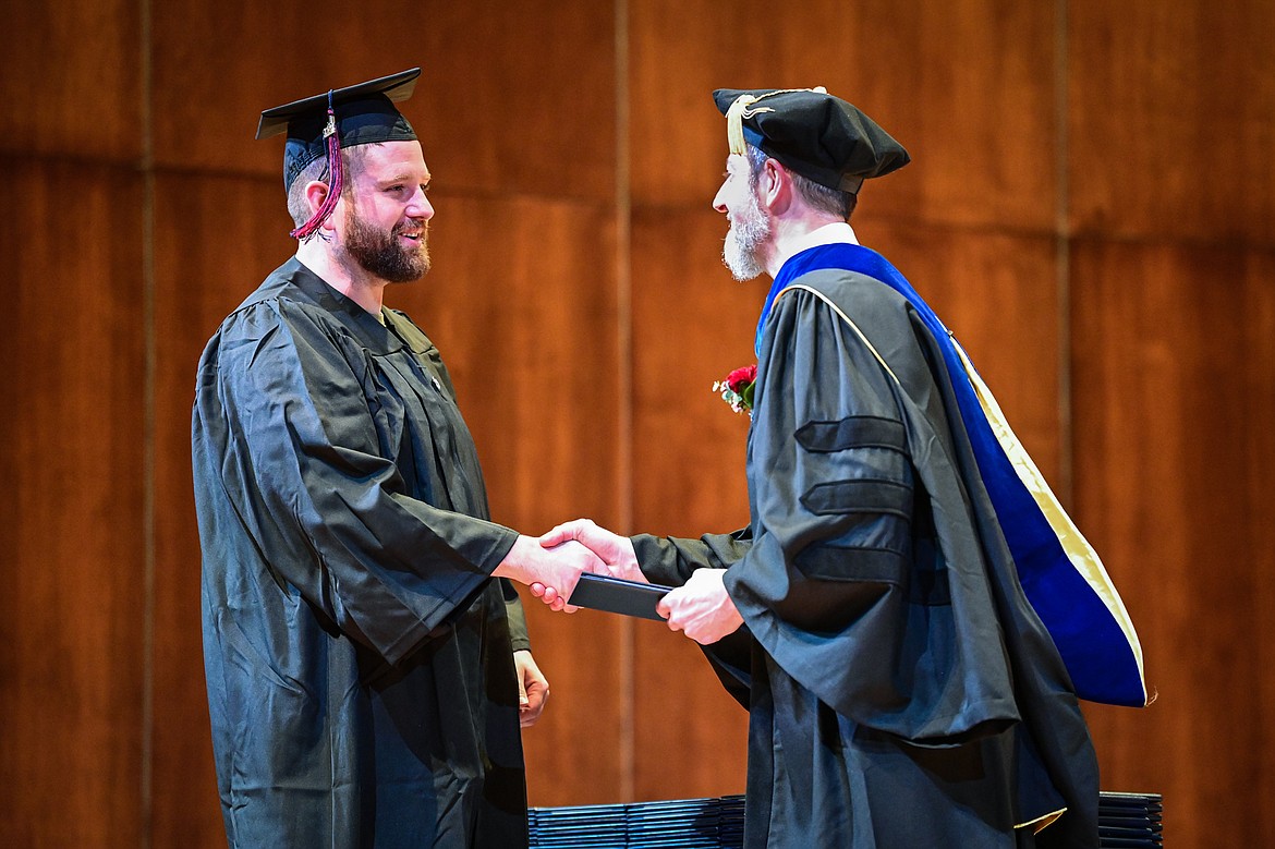 A graduate smiles as he receives his degree from Bryan Brophy-Baermann, vice president of Academic and Student Affairs, at Flathead Valley Community College's Class of 2024 commencement ceremony inside McClaren Hall at the Wachholz College Center on Friday, May 10. A total of 271 students were honored earning 292 degrees and certificates. (Casey Kreider/Daily Inter Lake)