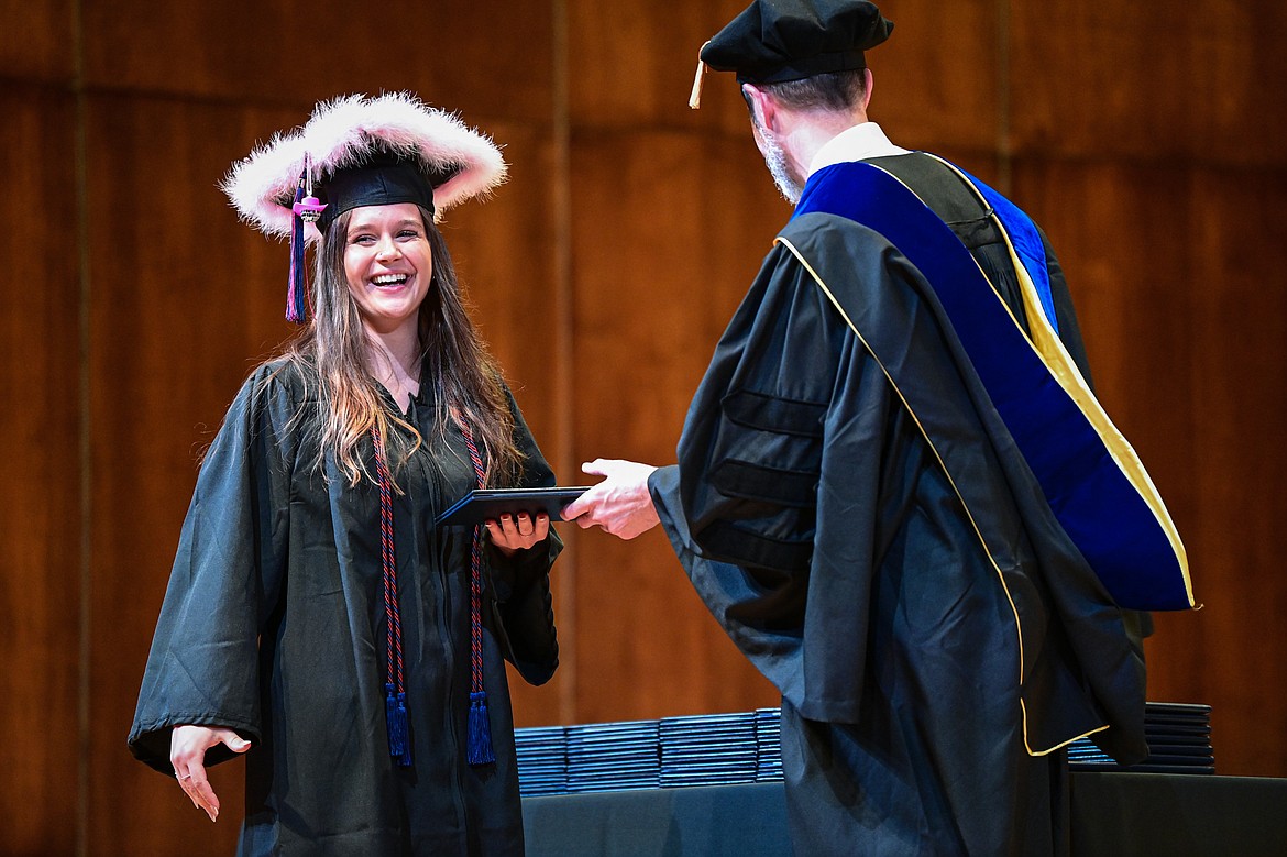 A graduate smiles as she receives her degree from Bryan Brophy-Baermann, vice president of Academic and Student Affairs, at Flathead Valley Community College's Class of 2024 commencement ceremony inside McClaren Hall at the Wachholz College Center on Friday, May 10. A total of 271 students were honored earning 292 degrees and certificates. (Casey Kreider/Daily Inter Lake)