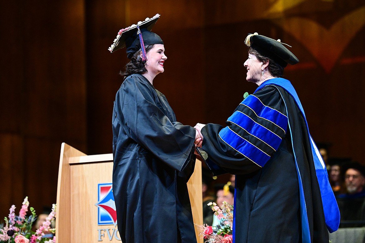 Flathead Valley Community College President Jane Karas shakes the hand of graduate Lydia Osborne after receiving her degree at FVCC's Class of 2024 commencement ceremony inside McClaren Hall at the Wachholz College Center on Friday, May 10. A total of 271 students were honored earning 292 degrees and certificates. (Casey Kreider/Daily Inter Lake)