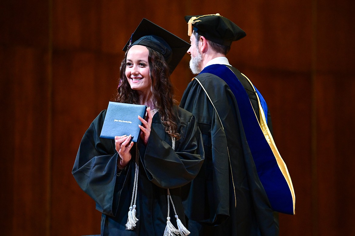 A graduate smiles as she receives her degree from Bryan Brophy-Baermann, vice president of Academic and Student Affairs, at Flathead Valley Community College's Class of 2024 commencement ceremony inside McClaren Hall at the Wachholz College Center on Friday, May 10. A total of 271 students were honored earning 292 degrees and certificates. (Casey Kreider/Daily Inter Lake)