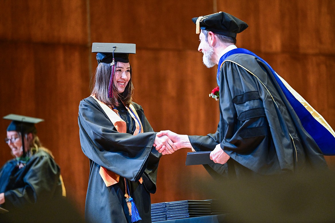 A graduate smiles as she receives her degree from Bryan Brophy-Baermann, vice president of Academic and Student Affairs, at Flathead Valley Community College's Class of 2024 commencement ceremony inside McClaren Hall at the Wachholz College Center on Friday, May 10. A total of 271 students were honored earning 292 degrees and certificates. (Casey Kreider/Daily Inter Lake)