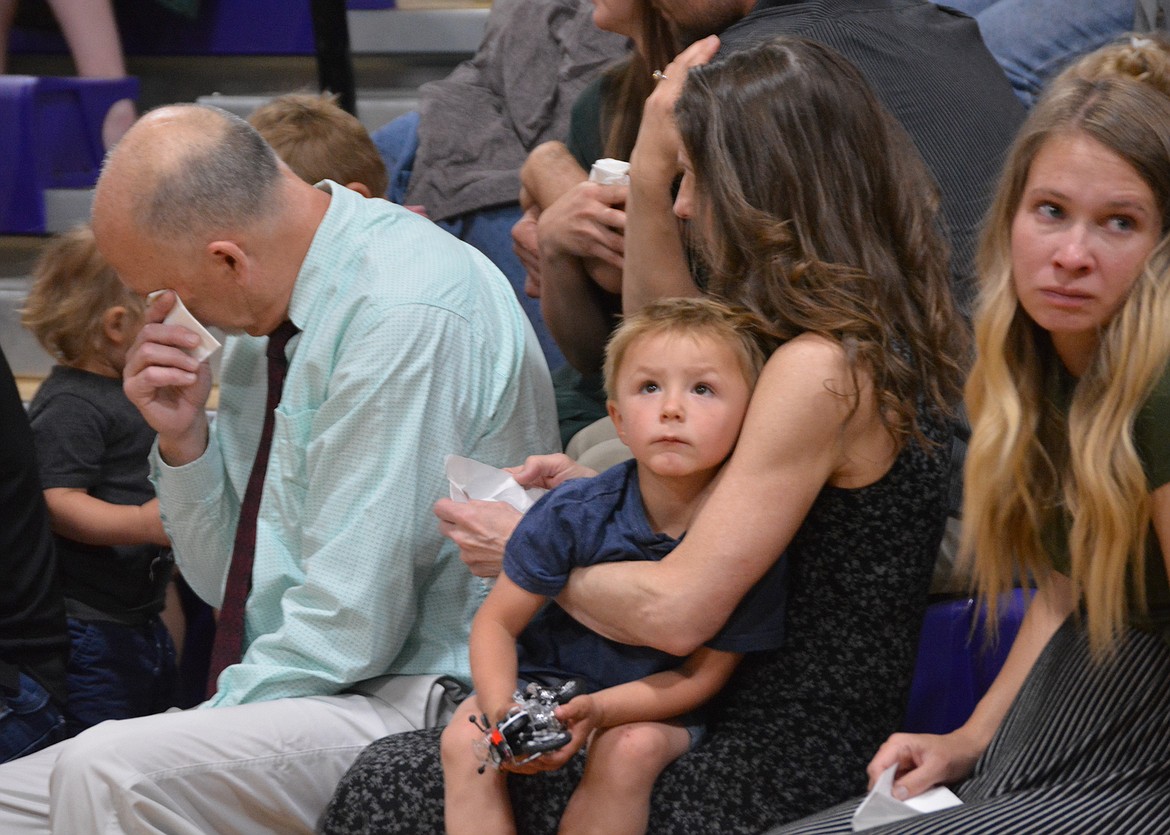 Steve Louthan wipes his eyes during the celebration of life for Gene Jacobs at Kellogg High School. Seated next to him holding one of the little ones, Deb Louthan, right said they thought Gene would have liked seeing all of their 30 family members in attendance.