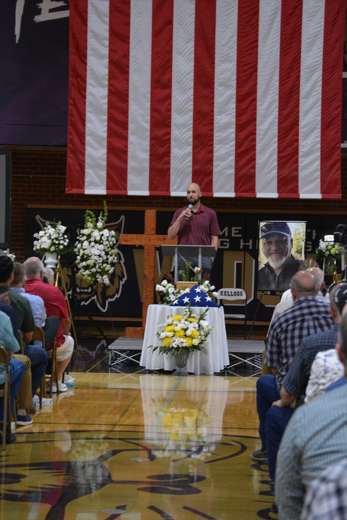 Kevin Kessler of Real Life Ministries addresses those gathered for the celebration of life for Gene Jacobs at Kellogg High School Saturday.