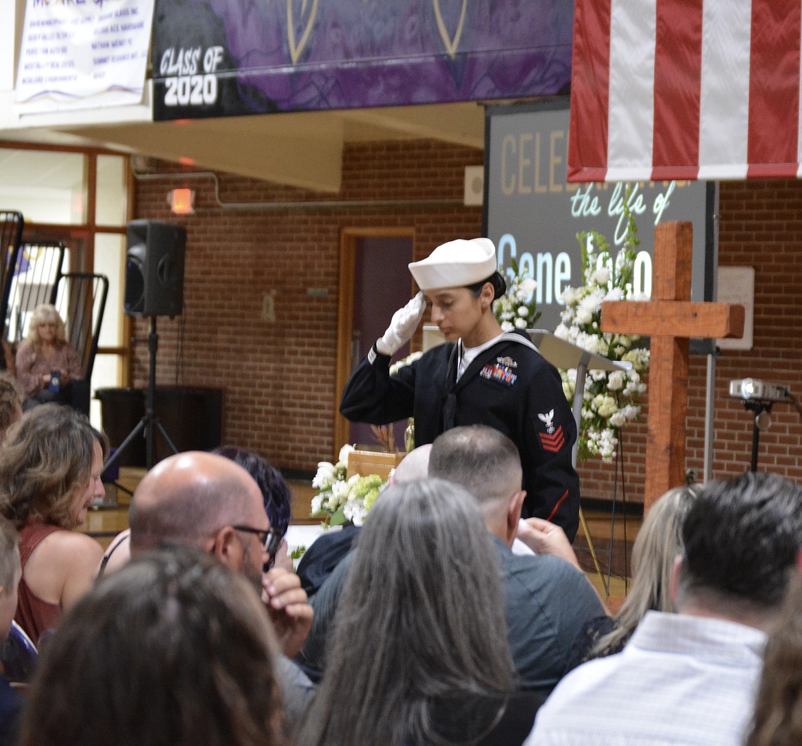 A folded flag is presented to Christy Jacobs and family at a funeral service for Gene Jacobs Saturday at Kellogg High School. Et1 Joseline Gomez-Lopez of the U.S. Navy presents the Jacobs family with the military honors bestowed to Gene Jacobs upon his passing.