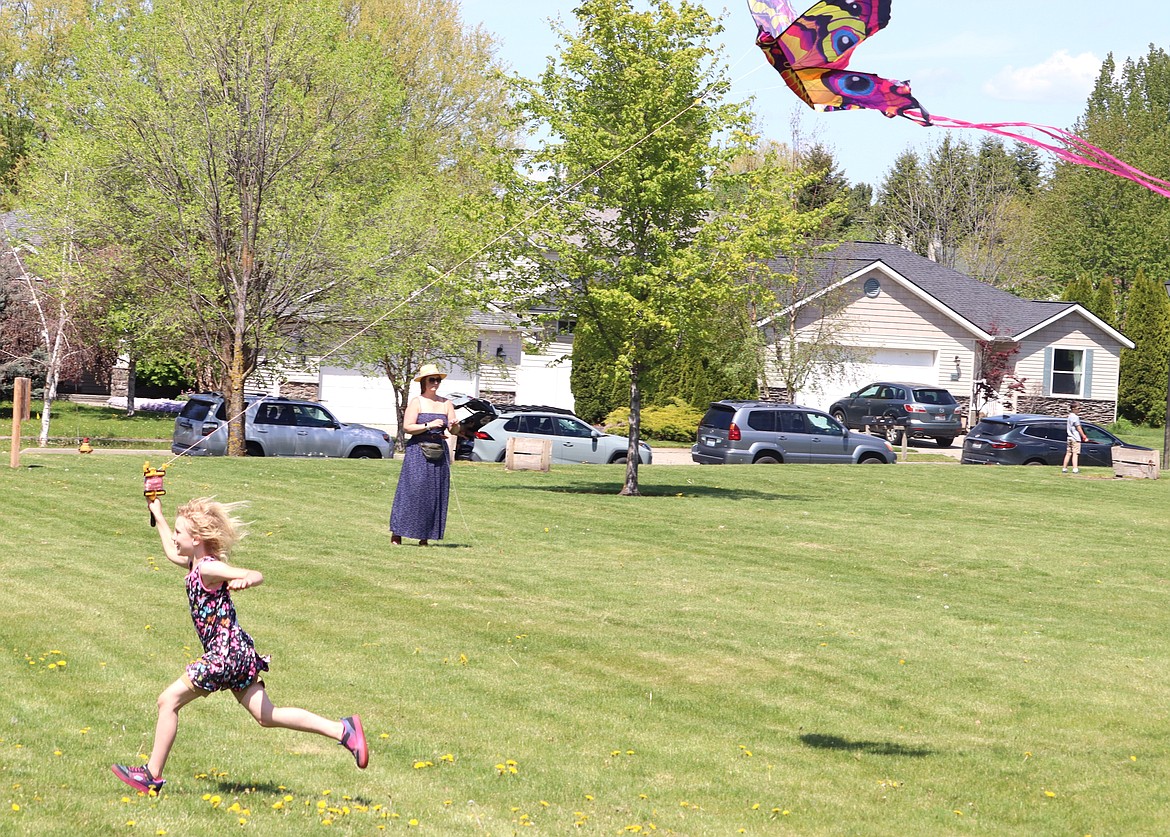 Lily Hill runs to get her kite in the air during the Hayden Kite Festival on Saturday. Kids and parents turned out for the annual event on a sunny afternoon at Broadmoore Park.