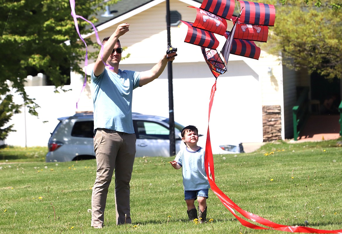 Connor Hollman gives his son Henik a little help during the Hayden Kite Festival at Broadmoore Park on Saturday.