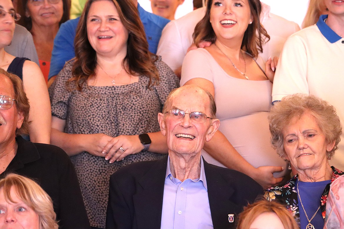 Ray Johnson, surrounded by family and friends, smiles for a picture as he celebrates his 100th birthday at the Coeur d'Alene Eagles on Saturday.