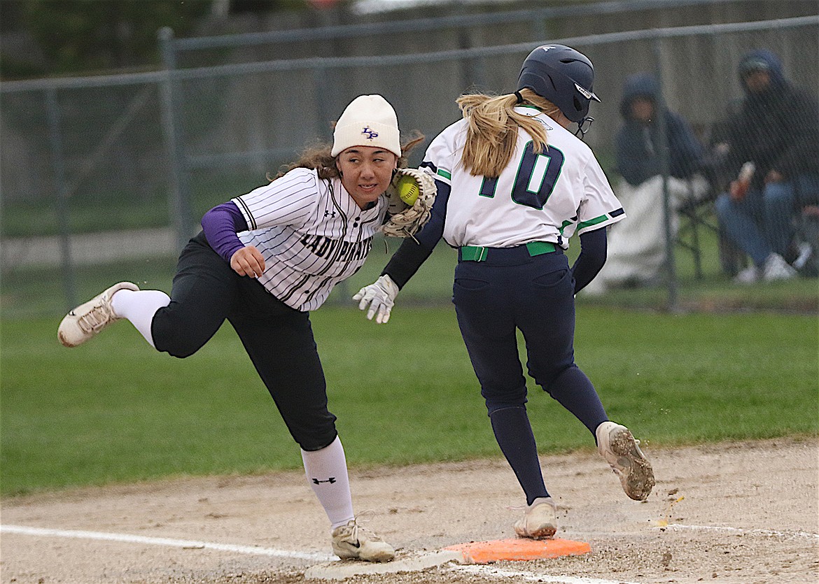 Polson's Olivia Jore dispatches a Glacier High player at first base. (Bob Gunderson photo)