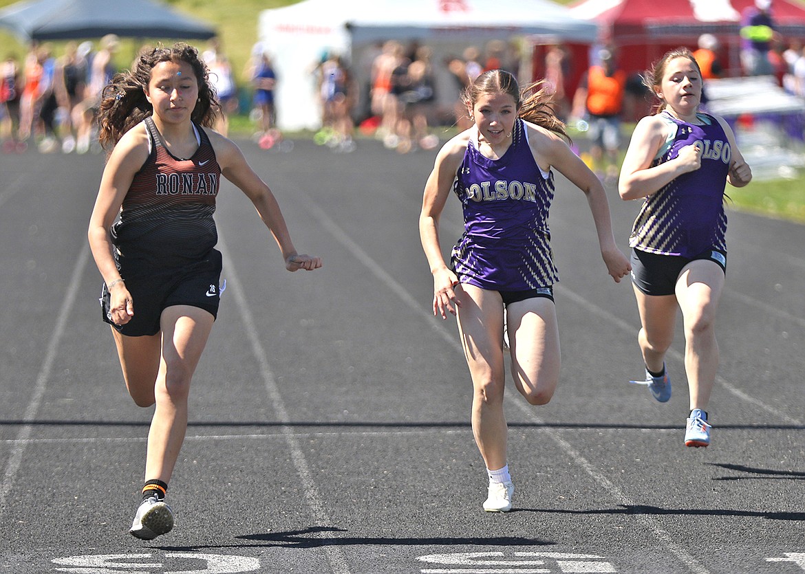 Ronan's Destiny Finley outpaces Polson's Alyssia Black in the 100-meter run at Saturday's ABC Invite in Polson. (Bob Gunderson photo)