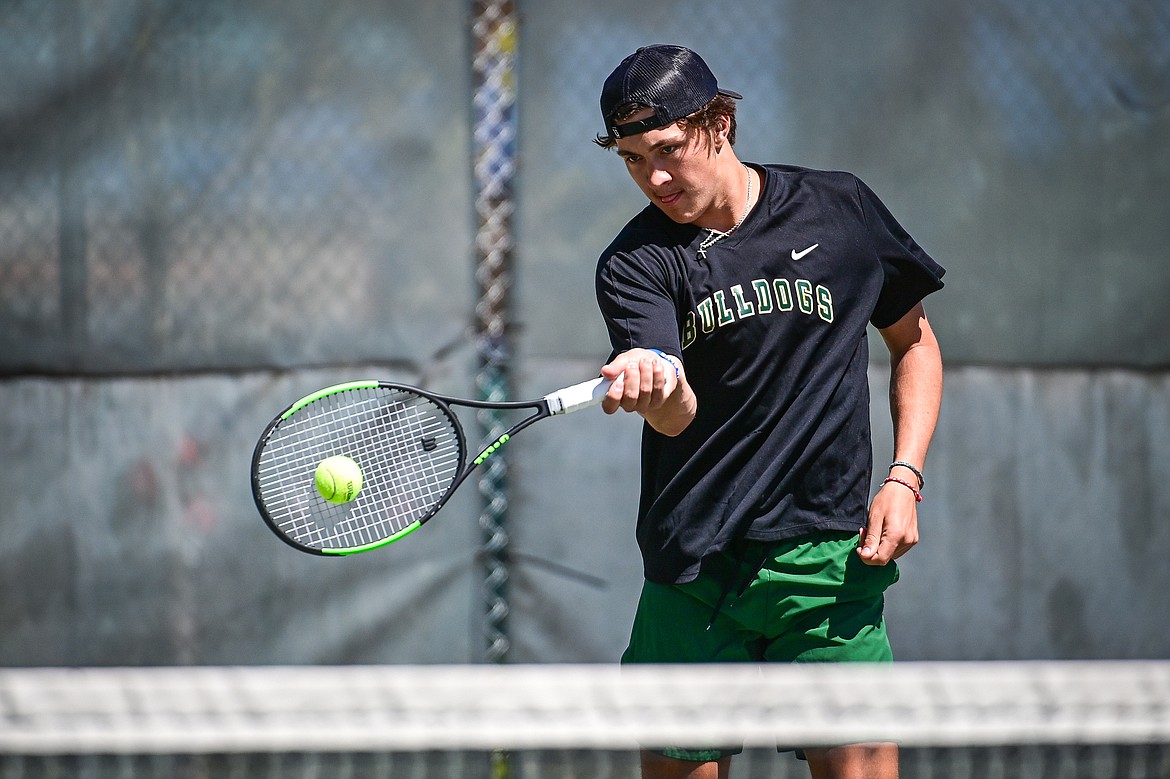 Whitefish's Mason Kelch hits a return in a boys doubles match with teammate Dane Hunt against Bigfork at Riverside Park in Whitefish on Thursday, May 9. (Casey Kreider/Daily Inter Lake)