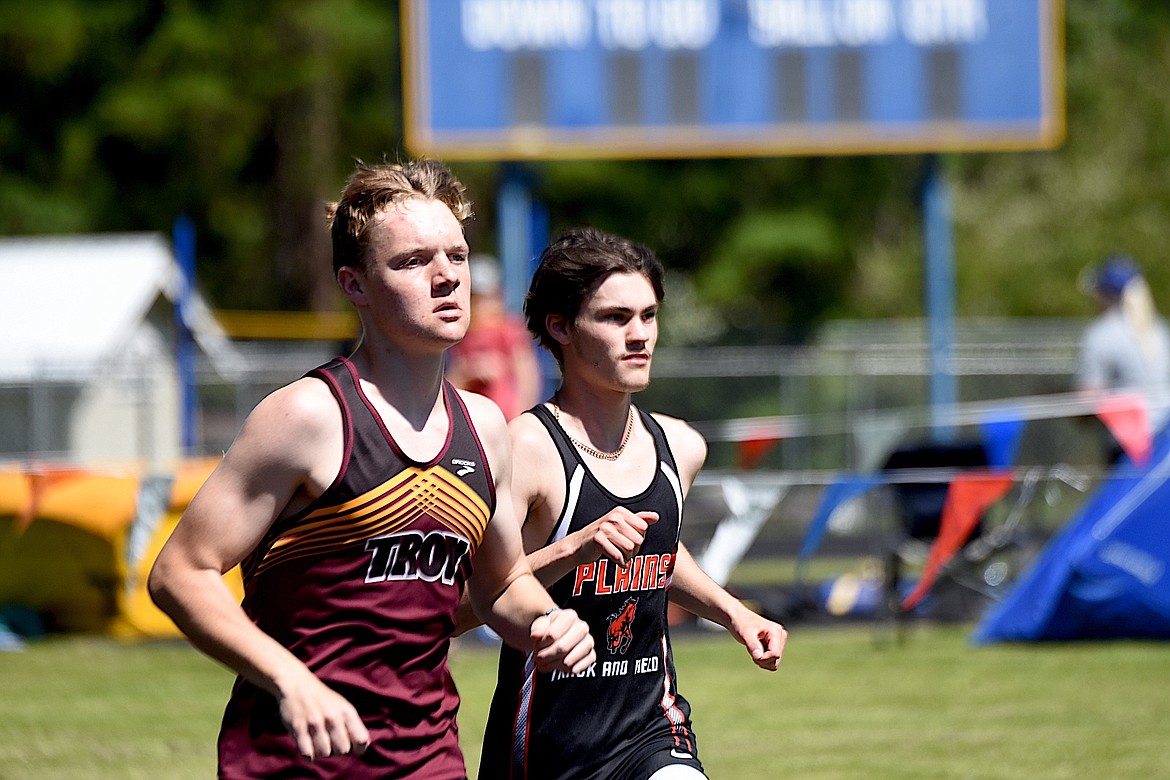 Plains junior Mike Reistroffer, right, runs with Troy's Nolan Morris in the 1,600-meter run Saturday, May 11 at 7B District Track and Field Meet in Libby. Reistroffer placed fourth in the event. (Scott Shindledecker/The Western News)