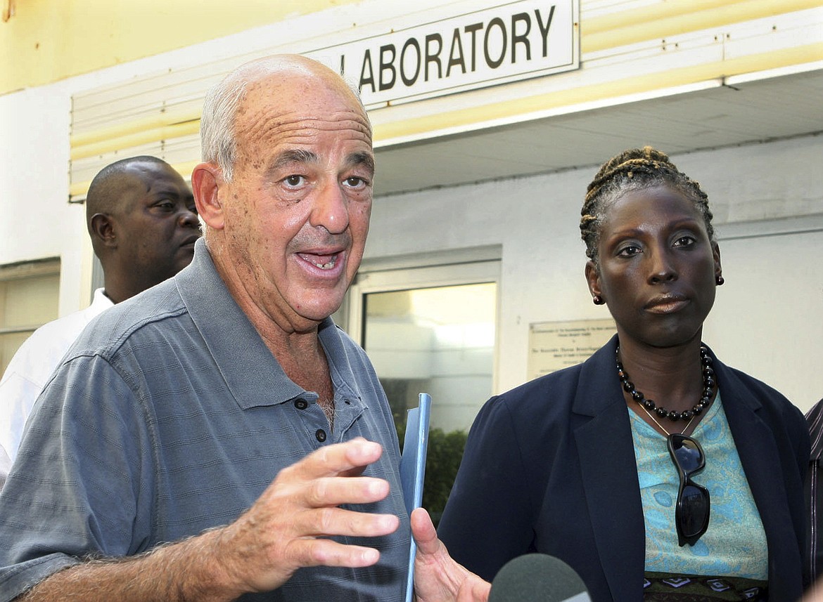 Pathologist Dr. Cyril Wecht, center, talks to the media while Bahamas' head coroner Linda Virgil, right, and attorney Michael Scott, left, listen outside the Rand Laboratory morgue at the Princess Margaret Hospital in Nassau, Bahamas, Sept. 17, 2006. Wecht, a pathologist and attorney whose biting cynicism and controversial positions on high-profile deaths such as President John F. Kennedy’s 1963 assassination caught the attention of prosecutors and TV viewers alike, died Monday, May 13, 2024. He was 93. (AP Photo/Tim Aylen, File)