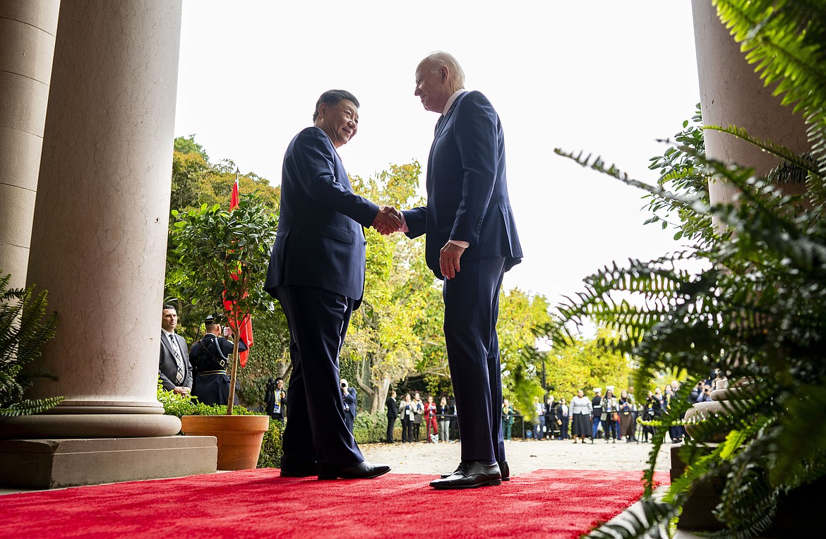 FILE -President Joe Biden, right, greets China's President President Xi Jinping, left, at the Filoli Estate in Woodside, USA, Wednesday, Nov. 15, 2023. High-level envoys from the United States and China are set to meet in Geneva for talks about artificial intelligence including the risks of the technology and ways to set shared standards to manage it. The meeting Tuesday is billed as an opening exchange of views in an inter-governmental dialogue on AI agreed during a meeting between U.S. President Joe Biden and Chinese President Xi Jinping in San Francisco. (Doug Mills/The New York Times via AP, Pool, File)