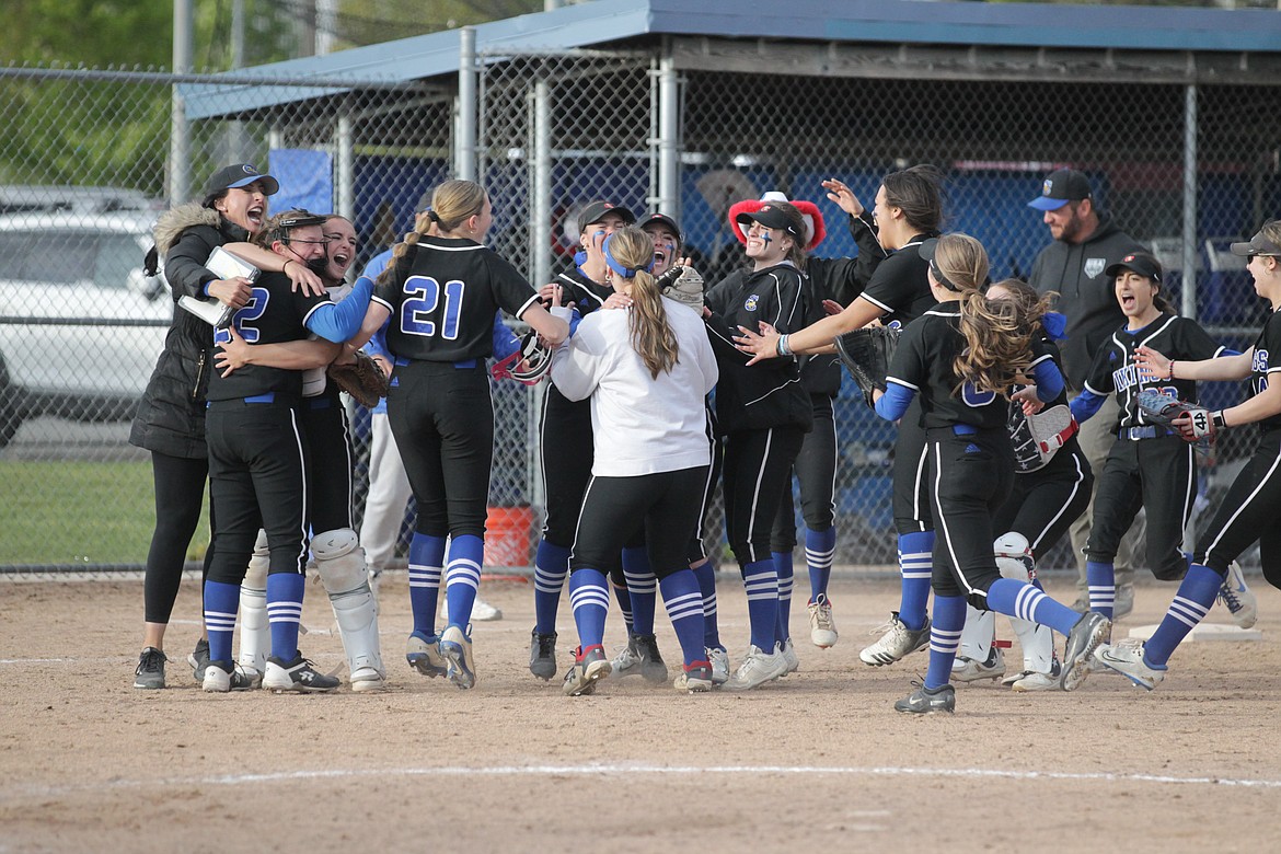 MARK NELKE/Press
Coeur d'Alene High players and coaches celebrate last week after the Vikings won their third straight 5A Region 1 softball title.