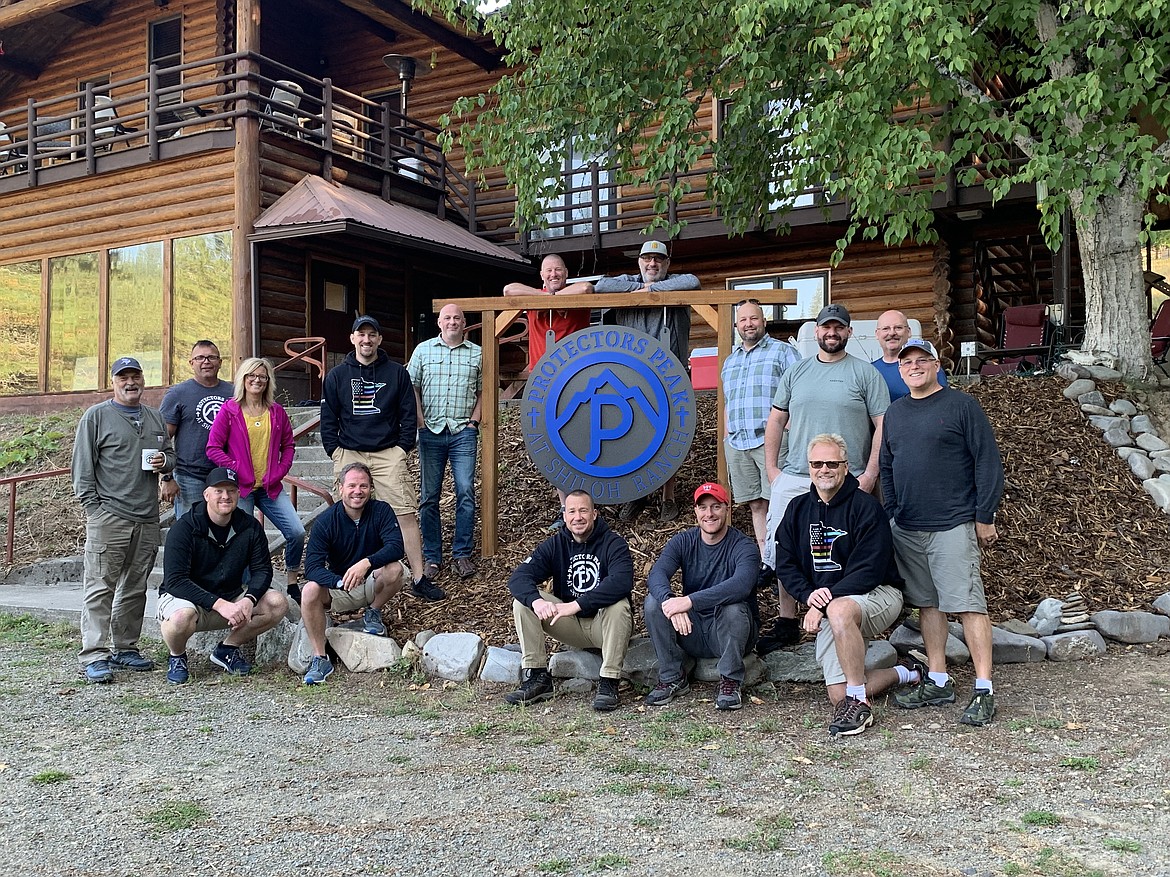 Officers on a retreat at Shiloh Ranch, now known as Protectors' Peak pose for a picture outside the ranch.