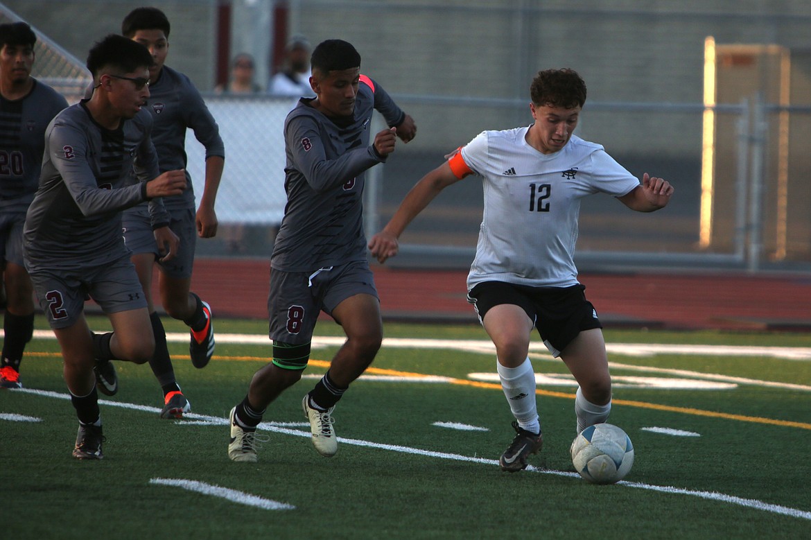 Royal senior Santiago Gonzalez (12) turns around to create space between himself and Wahluke defenders before firing off a shot to score the game-winning goal against the Warriors on Saturday.